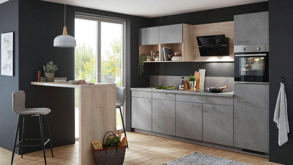 Modern gray kitchen with black accent walls, wood-tone cabinetry, built-in oven, and a wooden breakfast bar with stools