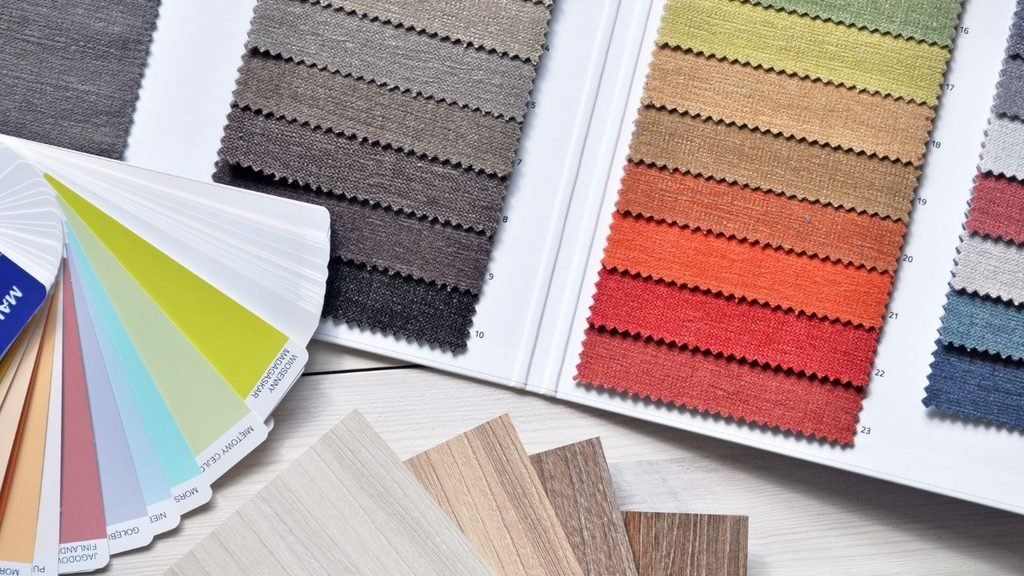 Interior design color palette board with coordinated fabric swatches and wood veneer samples in warm neutral tones
