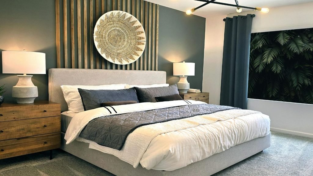 Modern bedroom with dark green accent wall, wood slat headboard detail, and round woven wall art