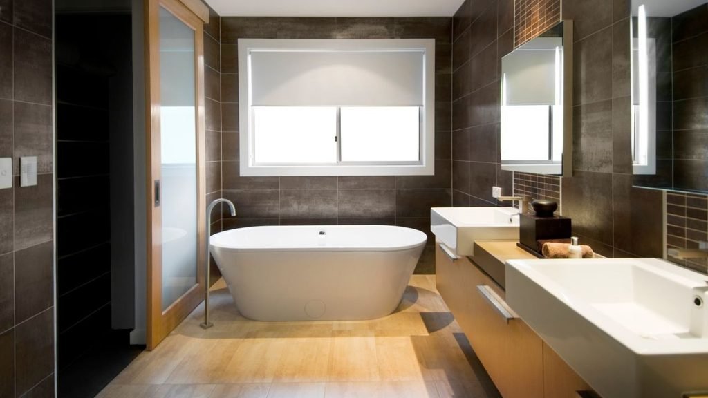 Modern bathroom with brown tile walls and a freestanding tub, a contrast to beadboard wainscoting bathroom pictures