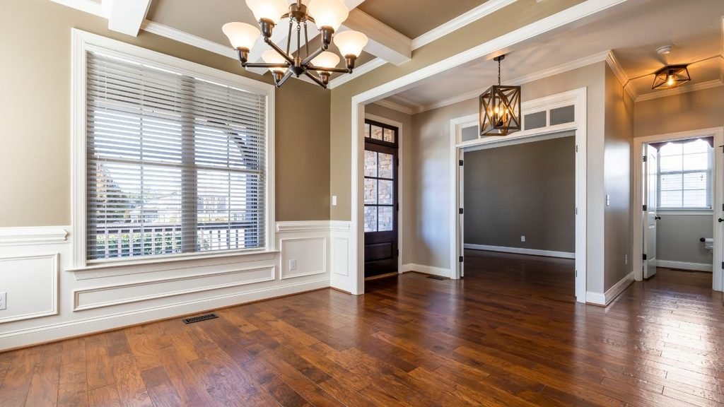 Images of beadboard wainscoting alternatives: dining room with white raised panel wainscoting, crown molding and dark hardwood floor