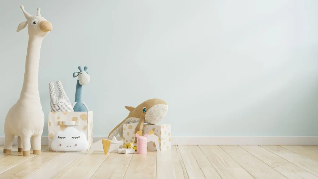 Soft pastel wallpaper for wall colors in a cozy nursery decorated with plush toys and storage boxes.