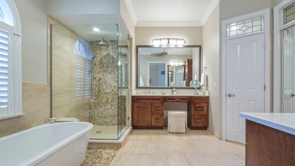 Bathroom remodel ideas for a master bathroom: freestanding tub, glass walk-in shower and cherry wood makeup vanity