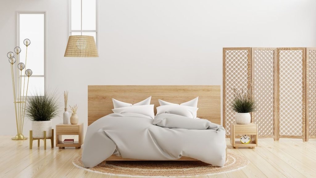 Minimalist cosy interior ideas for a bright bedroom with a light wood bed, rattan pendant lamp and a carved wooden folding screen