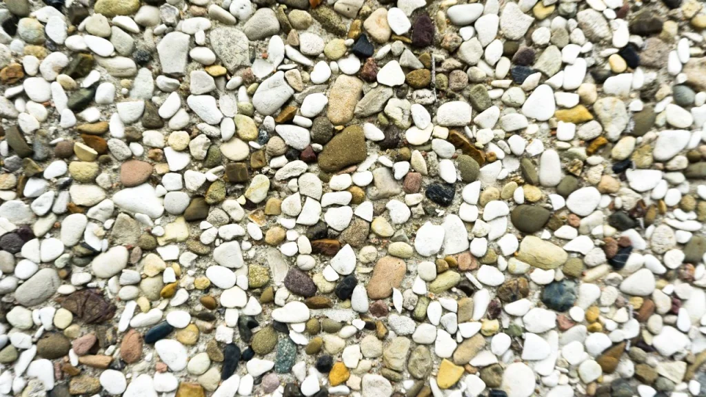 Detailed close-up of mixed pebble stone texture ideal for creative wallpaper for wall murals and rustic designs.