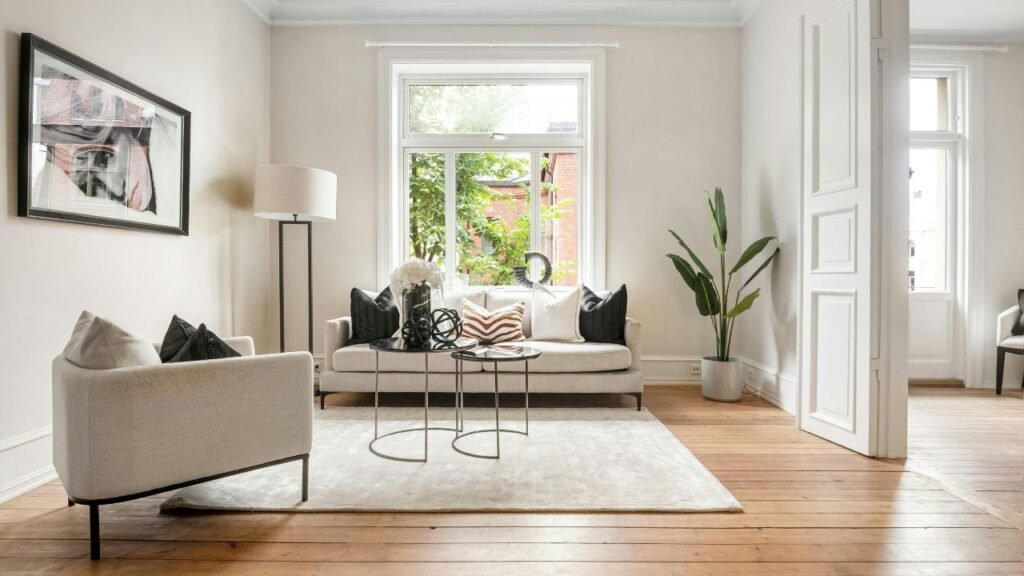 Bright living room with cream walls, crown molding and baseboards, an alternative to pictures of beadboard wainscoting