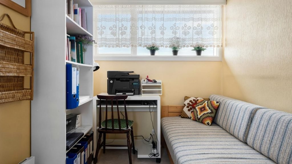 Tiny bedroom with a daybed, white desk and shelves, a starting point for room setup ideas for a small bedroom gaming room