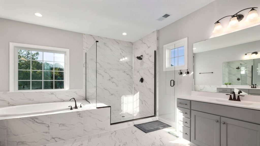 Bathroom remodel ideas with tile: marble-look walls and floor, glass shower, soaking tub and matte black fixtures